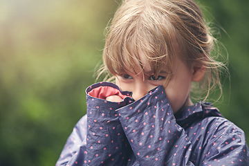 Image showing Shes a shy cutie pie. Shot of a shy little girl standing outside.