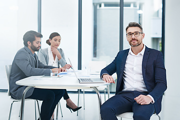 Image showing Come on in, were just about to get started. Portrait of a handsome businessman sitting in the boardroom during a meeting.