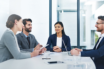 Image showing Gathered around the boardroom table. Shot of a group of corporate businesspeople meeting in the boardroom.