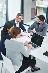 Image showing Getting down to business. High angle shot of a group of corporate businesspeople meeting in the boardroom.