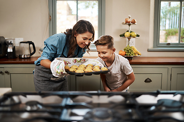 Image showing Nothing beats the smell of homemade muffins. Shot of a woman and her son baking together in the kitchen at home.