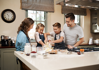 Image showing Nothing tastes as good as something prepared by the whole family. Cropped shot of a young family baking in the kitchen at home.