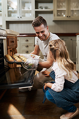 Image showing Your muffins came out so perfect. Cropped shot of a young girl and her father baking at home.