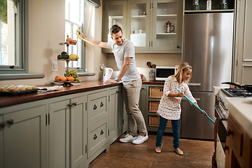 Image showing Were giving mom the day off. Shot of a young man and his daughter cleaning the kitchen at home.