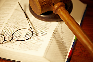 Image showing The meaning of justice. An open book with a gavel and block - justice.