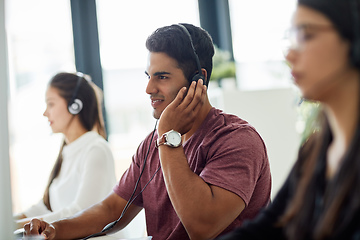 Image showing He has top-notch communication skills. Shot of a group of customer service representatives working at a desk.