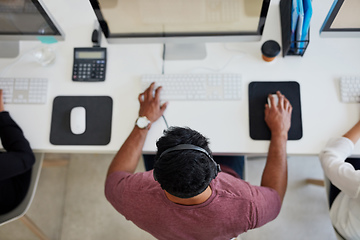 Image showing Conveying a solution quickly and effectively. Shot of a young call centre agent working at his desk.