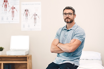 Image showing Helping you heal is my job. Portrait of a handsome mature male physiotherapist posing with his arms folded in his office.