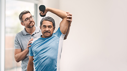 Image showing Proper technique is the main focus. Shot of a senior man exercising with dumbbells during a rehabilitation session with his physiotherapist.