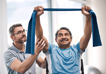 Image showing Hes raising the bar today. Shot of a senior man exercising with a resistance band during a rehabilitation session with his physiotherapist.