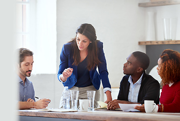 Image showing Listen to what Im saying. Cropped shot of a young businesswoman addressing her colleagues during a business meeting.