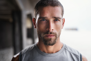 Image showing Hes not playing ant games about his fitness. Portrait of a handsome young sportsman looking serious while exercising outdoors.