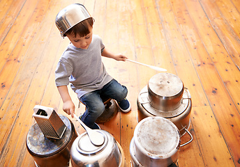 Image showing Kids rock. Shot of an adorable little boy drumming on pots and pans.