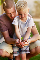 Image showing Its valuable to teach kids about nature. Cropped shot of a father and his little son holding a plant growing out of soil.