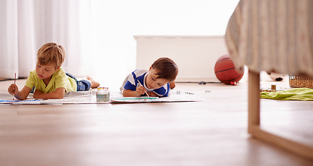 Image showing Letting their imaginations free. Shot of two young boys painting pictures at home.