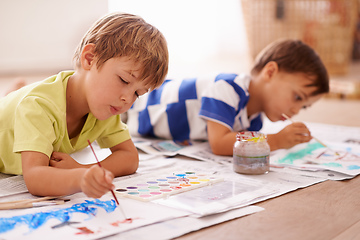 Image showing Unleashing their inner artists. Shot of two young boys painting pictures at home.