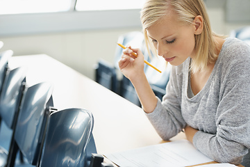 Image showing Focused on her studies. A beautiful college student studying in a classroom.