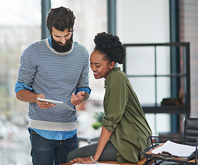 Image showing I use this app to schedule all my appointments. Cropped shot of two creative businesspeople looking at something on a tablet.