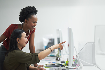 Image showing Can you believe he posted that picture. Cropped shot of a creative businesswoman showing her colleague something on her computer.