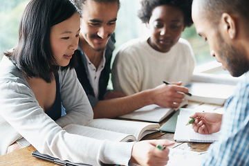 Image showing This problem is relatively simple.... A group of college students sitting together and studying.