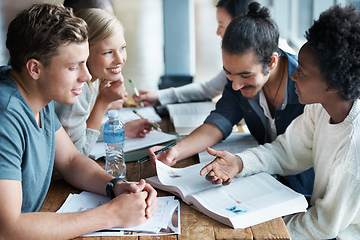 Image showing Cramming before an exam. A group of college students sitting together and studying.