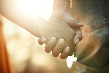 Image showing Their bond is too precious. Closeup shot of an adult holding a childs hand outside.