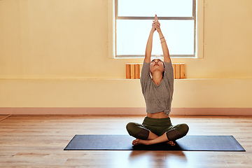 Image showing Reach for your true potential. Shot of a young women meditating during a yoga session.