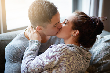 Image showing Passionate kisses on the couch. Shot of an affectionate young couple kissing on the sofa at home.