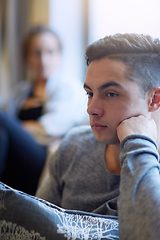 Image showing Hes not in the mood. Shot of a young man looking despondent after a fight with his girlfriend.