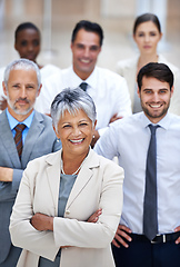 Image showing Corporate excellence Check. Portrait of a smiling businesswoman surrounded by a group of her colleagues.