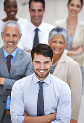 Image showing Why settle for mediocre when you can have amazing. Portrait of a smiling businessman surrounded by a group of his colleagues.