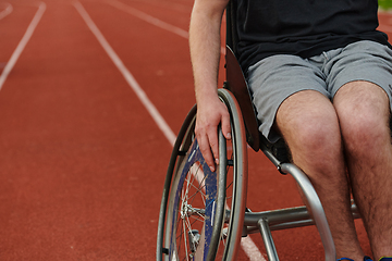 Image showing Close up photo of a person with disability in a wheelchair training tirelessly on the track in preparation for the Paralympic Games