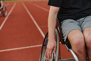 Image showing Close up photo of a person with disability in a wheelchair training tirelessly on the track in preparation for the Paralympic Games