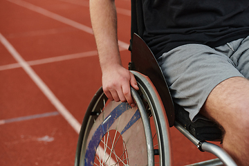 Image showing Close up photo of a person with disability in a wheelchair training tirelessly on the track in preparation for the Paralympic Games