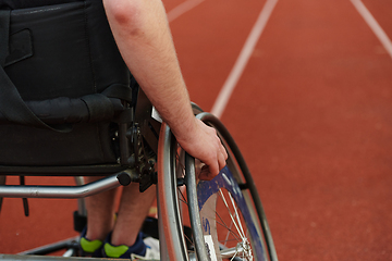 Image showing Close up photo of a person with disability in a wheelchair training tirelessly on the track in preparation for the Paralympic Games