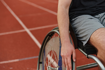 Image showing Close up photo of a person with disability in a wheelchair training tirelessly on the track in preparation for the Paralympic Games