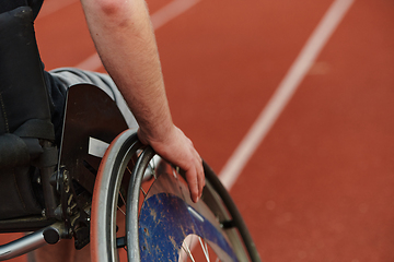 Image showing Close up photo of a person with disability in a wheelchair training tirelessly on the track in preparation for the Paralympic Games