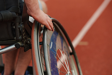 Image showing Close up photo of a person with disability in a wheelchair training tirelessly on the track in preparation for the Paralympic Games