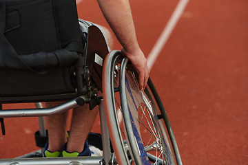 Image showing Close up photo of a person with disability in a wheelchair training tirelessly on the track in preparation for the Paralympic Games