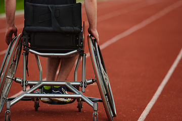 Image showing Close up photo of a person with disability in a wheelchair training tirelessly on the track in preparation for the Paralympic Games