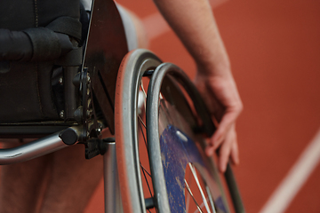 Image showing Close up photo of a person with disability in a wheelchair training tirelessly on the track in preparation for the Paralympic Games