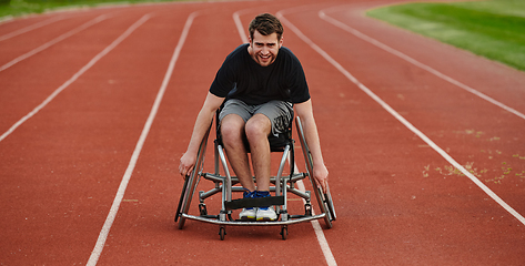 Image showing A person with disability in a wheelchair training tirelessly on the track in preparation for the Paralympic Games