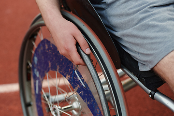 Image showing Close up photo of a person with disability in a wheelchair training tirelessly on the track in preparation for the Paralympic Games