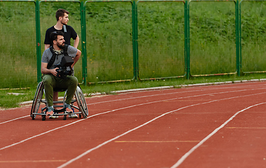 Image showing A cameraman filming the participants of the Paralympic race on the marathon course