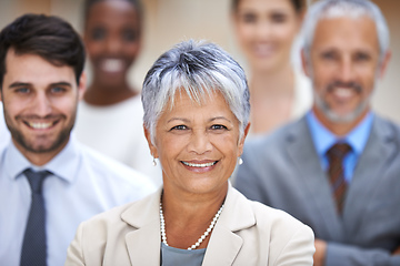 Image showing Positive things happen to positive people. Portrait of a smiling businesswoman surrounded by a group of her colleagues.