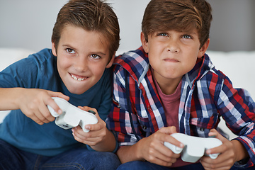 Image showing Ive got you this time. Shot of two young boys playing video games at home.