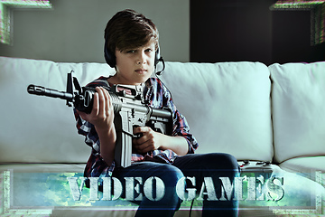 Image showing Lock and load time. Shot of a young boy playing violent video games.