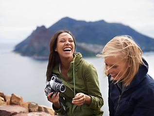 Image showing You shouldve seen your face in that last shot. A shot of two young women laughing on the side of the road during their trip.