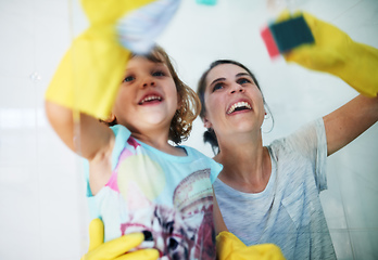 Image showing Making chores fun. Shot of a mother and daughter doing chores together at home.