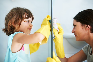 Image showing Scrub till it shines. Shot of a mother and daughter doing chores together at home.